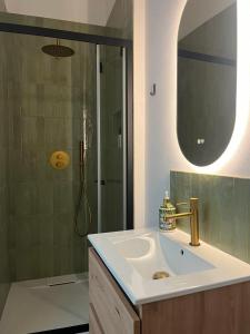 a bathroom with a sink and a shower at Quinta Do Priorado in Moncarapacho