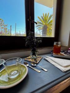 a table with a plate and a glass on a window at Ara Solis in Arola +30 photos