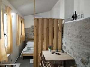 a room with a table and two beds in it at The Garden House in Boiano