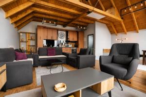 a living room with couches and a table at Black Villa in Prizren
