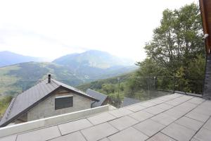a view of a roof with mountains in the background at Black Villa in Prizren