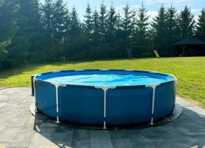 a large blue hot tub sitting on a patio at Mazury w Zasięgu in Brajniki