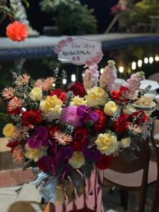 a bouquet of flowers in a vase on a table at Mây Retreat in Nguyên Ngoại