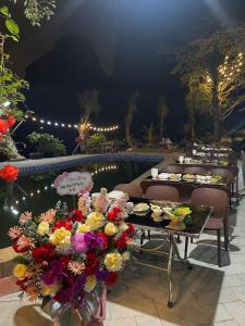 a group of tables with food and flowers on them at Mây Retreat in Nguyên Ngoại