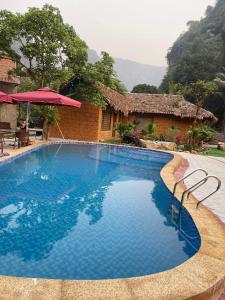a swimming pool in front of a house at Mây Retreat in Nguyên Ngoại