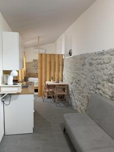 a kitchen and dining room with a stone wall at The Garden House in Boiano