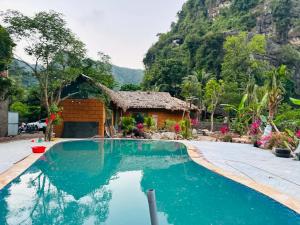 a swimming pool in front of a house at Mây Retreat in Nguyên Ngoại