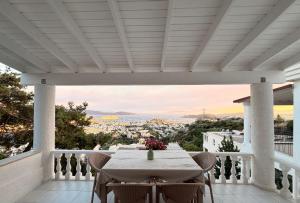 a table on a balcony with a view of the city at BODRUM BURCU VILLA , Magnificent Sea View, Cozy, Free Otopark, Free Wifi in Bodrum City