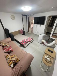 a living room with a couch and a flat screen tv at T2 avec terrasse privative Berre-l'Étang in Berre-lʼÉtang