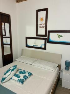 a bedroom with a bed with two pillows on it at Almarè in Grottammare