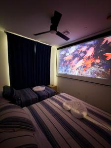 a bedroom with a large tv and a bed at 1 Block to Beach 150" Theater PS5 Arcade in Seaside Heights