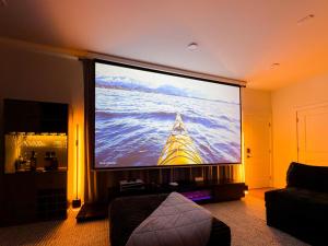 a large flat screen tv in a living room at 1 Block to Beach 150" Theater PS5 Arcade in Seaside Heights