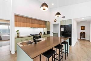 a kitchen with a large island with a sink at Tomakin Tonic in Tomakin