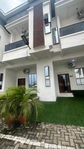 a house with two plants in front of it at Emilomo beautiful homes in Cardoso
