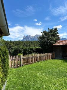 a fence in a yard with mountains in the background at Vorderschöneck 2 in Longostagno
