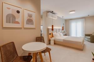 a bedroom with a bed and a table and chairs at Anema Living in Parga