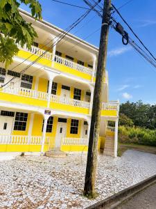 a yellow building with a white balcony at Papaya Condo in Portsmouth