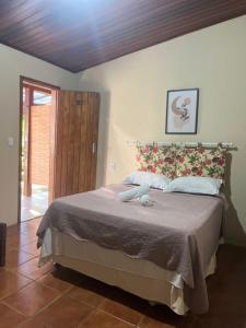 a bedroom with a large bed with a wooden ceiling at Pousada Almar in Itacaré +33 photos