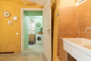 a bathroom with a sink and a washing machine at Dimora Pellegrino in Torre Pellice +67 photos