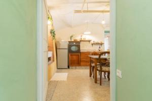 a kitchen with a table and a dining room at Dimora Pellegrino in Torre Pellice