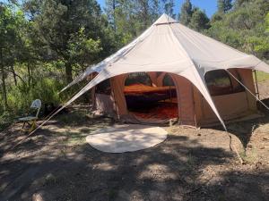 a tent is set up in a field at Pagosa Chi Camps in Pagosa Springs