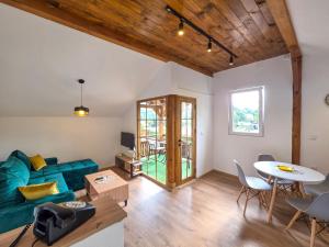 a living room with a blue couch and a table at na obali drine in Perućac