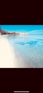 a view of a beach with water and buildings at La Gorgonia in Trapani +46 photos