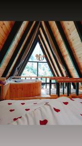 a bedroom with a bed and a large window at Kaçkin House ayder in Çamlıhemşin