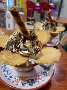 a bowl of ice cream with waffles and waffle cookies at La Gorgonia in Trapani