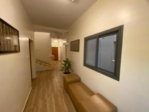 a living room with a couch and a window at Chamber double in Saly Portudal