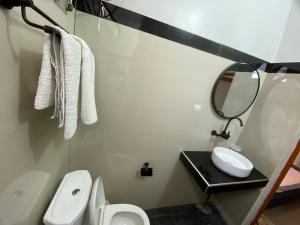 a bathroom with a sink and a toilet and a mirror at Chamber double in Saly Portudal +13 photos