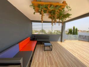 a living room with a red couch and a large window at Chamber double in Saly Portudal