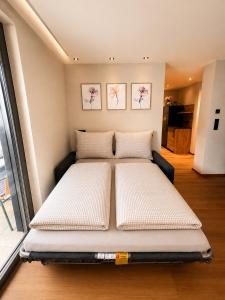 a bed in a room next to a window at NEU ab Juli 2026 - Apart Kneringer in Prutz