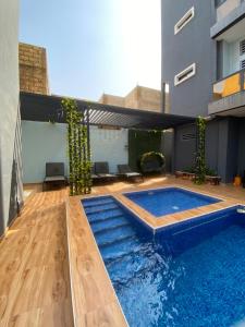 a swimming pool in the middle of a building at Chamber double in Saly Portudal