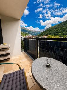 a table and chair on a balcony with a view at NEU ab Juli 2026 - Apart Kneringer in Prutz