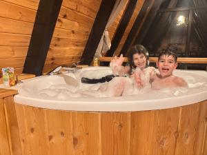 two children sitting in a bath tub at Kaçkin House ayder in Çamlıhemşin +62 photos
