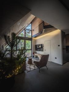 a large living room with a chair and a table at Anika - Mountain Home in Divčibare