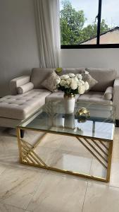 a living room with a couch and a glass coffee table at GG residencial in El Factor