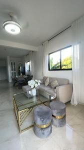 a living room with a couch and a glass table at GG residencial in El Factor
