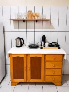 a kitchen with a sink and a counter top at Casa no Centro Vilhena in Vilhena +3 photos