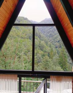a window view of a mountain view from a cabin at Kaçkin House ayder in Çamlıhemşin