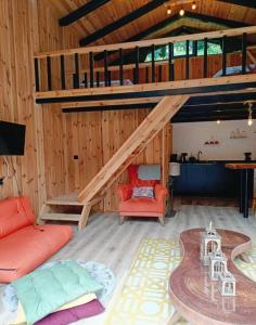 a living room with a staircase and a red couch at Kaçkin House ayder in Çamlıhemşin