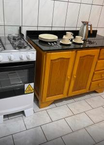 a kitchen with a stove and a stove top oven at Casa no Centro Vilhena in Vilhena