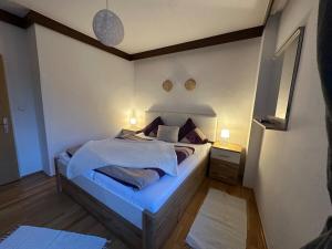 a bedroom with a bed with blue sheets and pillows at Max and Moritz Top 7 in Liebenau +2 photos
