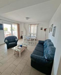 a living room with a couch and a table at Apartments Marino in Supetar
