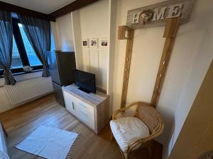 a living room with a tv and a chair at Max and Moritz Top 7 in Liebenau