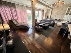 a living room with a couch and a table at Art-Villa SeLena in Bar