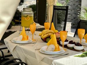 a table with plates of fruit and glasses of orange juice at Art-Villa SeLena in Bar