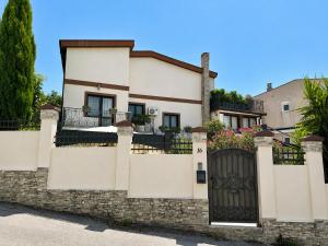 a house with a stone fence and a gate at Art-Villa SeLena in Bar