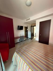 a hotel room with a bed and a desk at B&B Vescovo Rosso in Cosenza